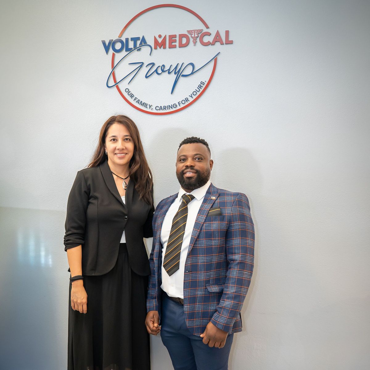 Maxwell Kwame Setsoafia and a colleague under the Volta Medical Group sign